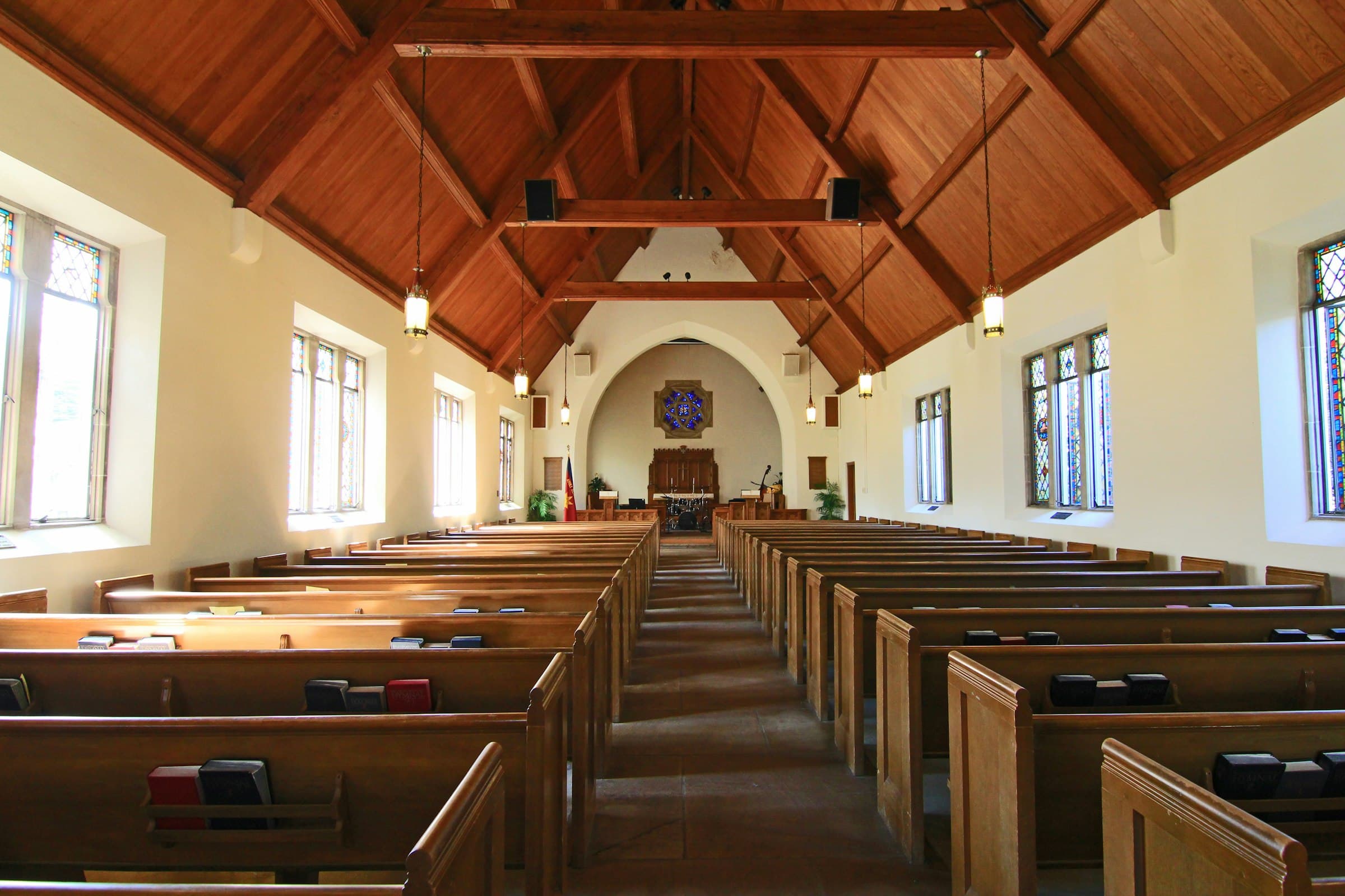 Wooden pews and warm light in a church sanctuary
